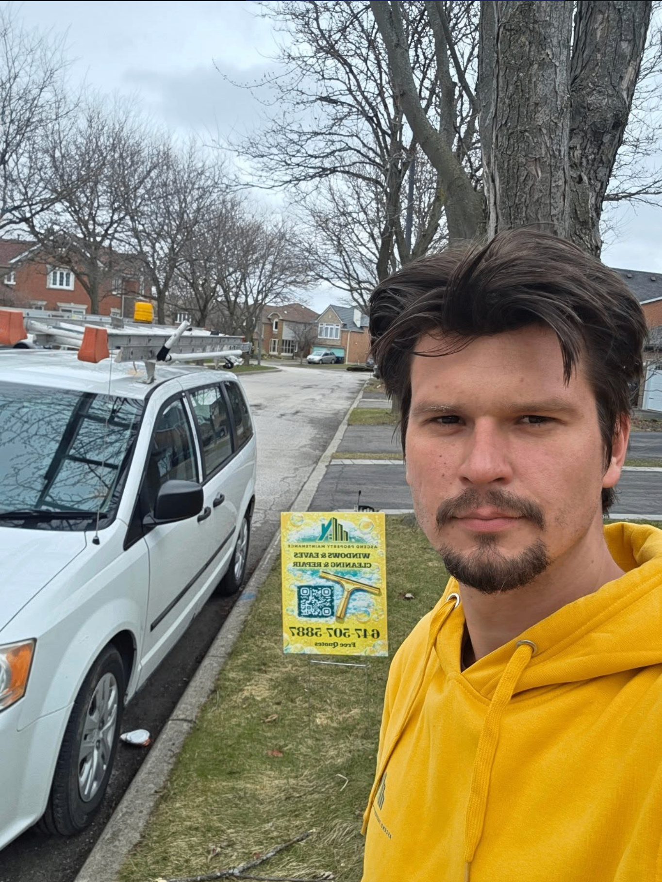 Eugene, founder of Ascend Property Maintenance, with the company van in Toronto